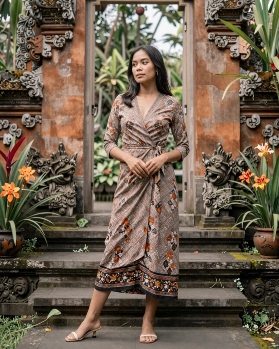 Indonesian woman in modern batik dress standing gracefully in a traditional Javanese garden